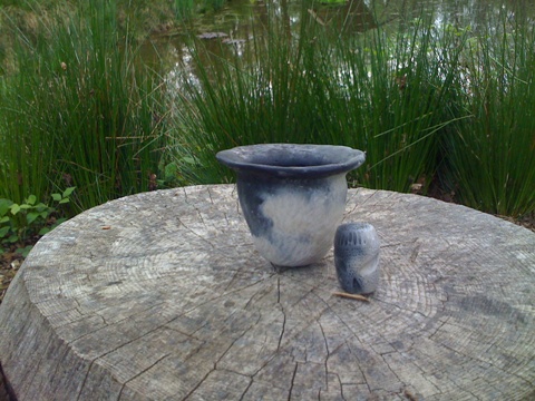 Finished pot and fire god - we dug clay from the pond beyond